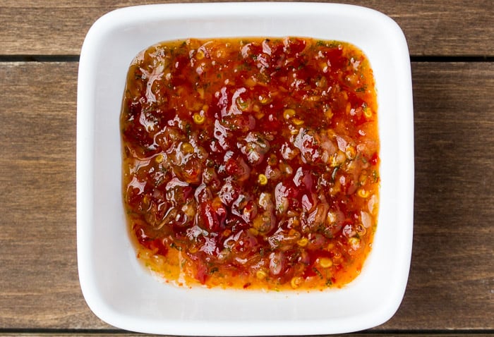 Sweet Chili Lime Sauce in a White Square Bowl over a wood background