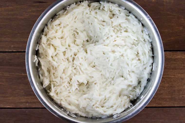 Creamy Coconut Rice Fully Cooked in a Silver Pot over a Wood Background