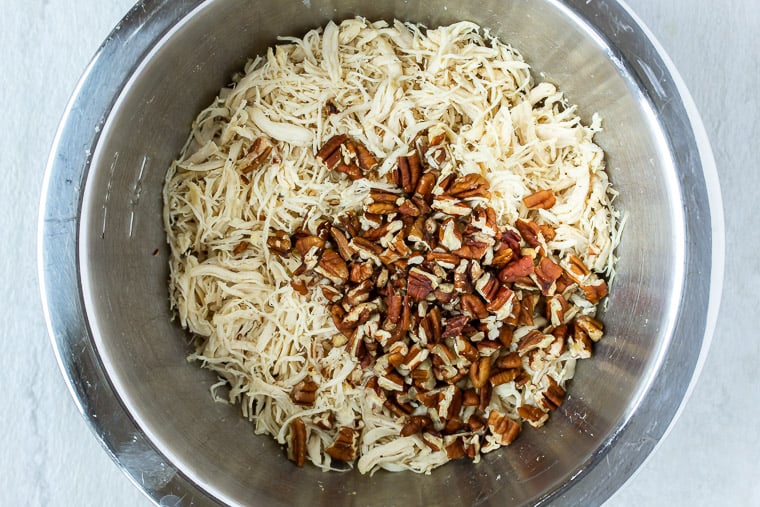 Shredded Chicken and Pecans in a silver mixing bowl