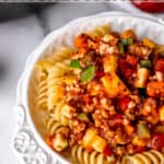 Vegetable spaghetti sauce over pasta with text overlay.