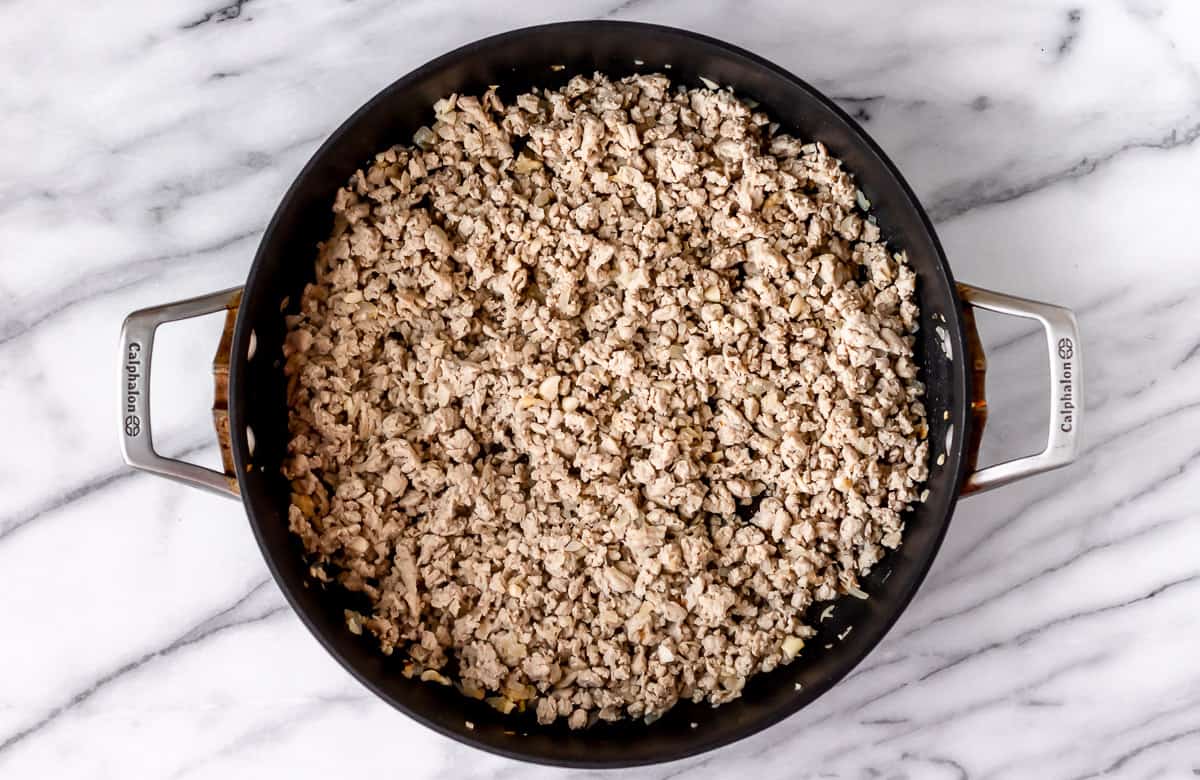 Cooked ground meat in a black skillet.