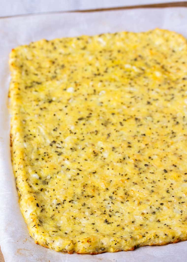 A baked cauliflower crust ready for toppings