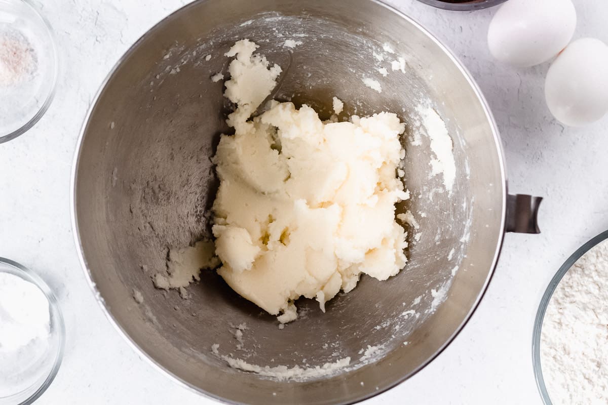 Butter and sugar creamed together in a silver mixing bowl