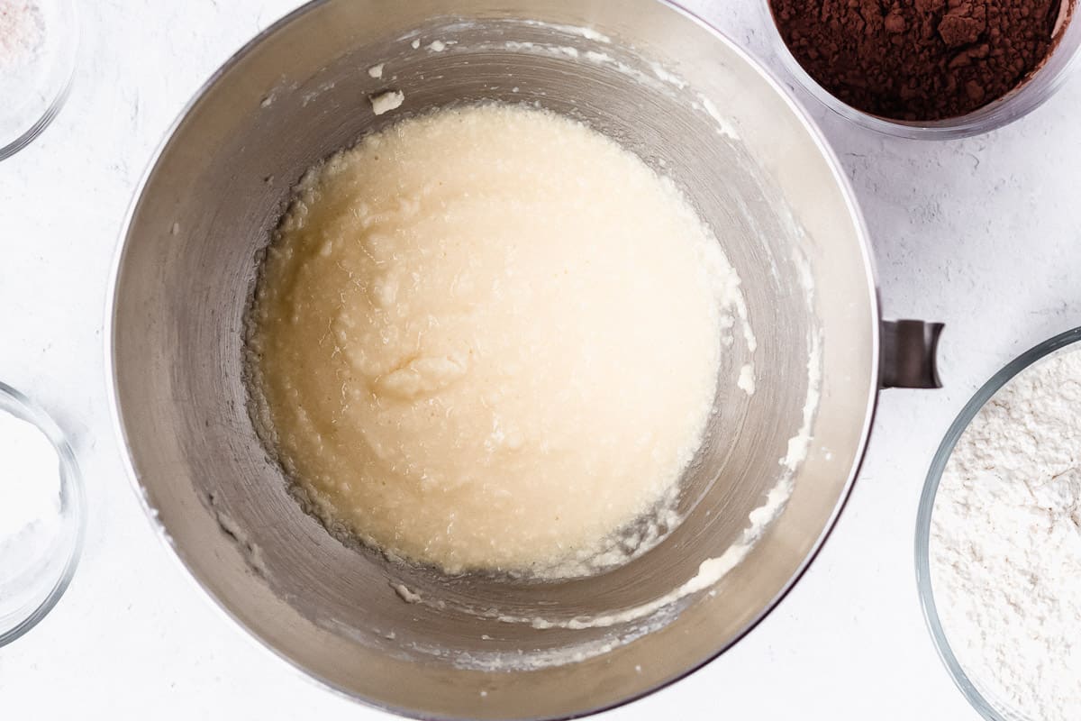Butter, sugar, eggs creamed together in a silver mixing bowl