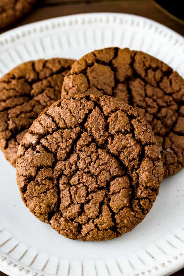 Close up of 3 gluten free chocolate cookies on a white plate