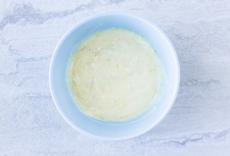 Roasted Garlic Lemon Aioli in a light blue bowl over a white background