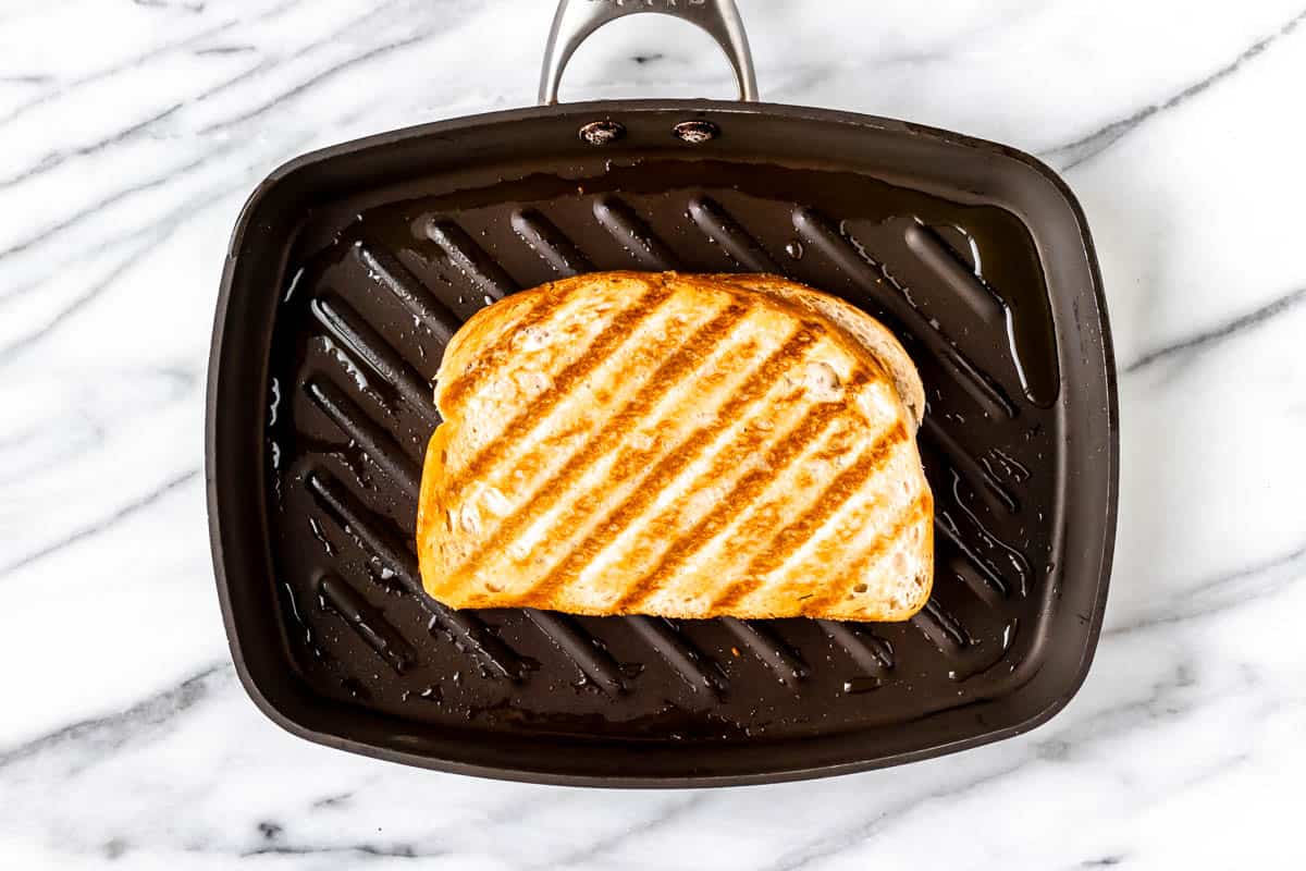 A grilled sandwich in a panini pan.