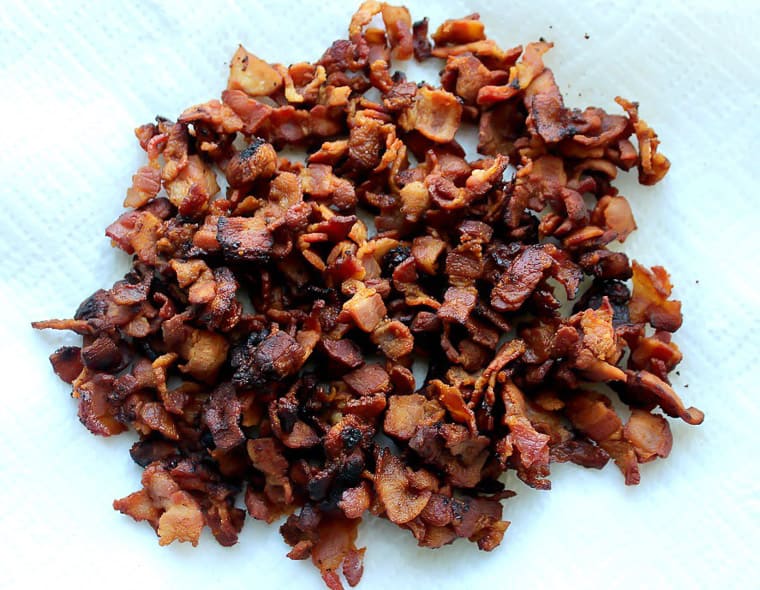 Cooked, diced bacon on a paper towel