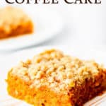 A single slice of pumpkin spice coffee cake with a second slice blurred in the background and text overlay