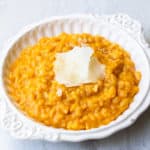 Pumpkin Spice Risotto in a white dish over a white background