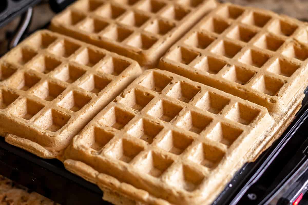 Cooked waffles in a waffle maker.