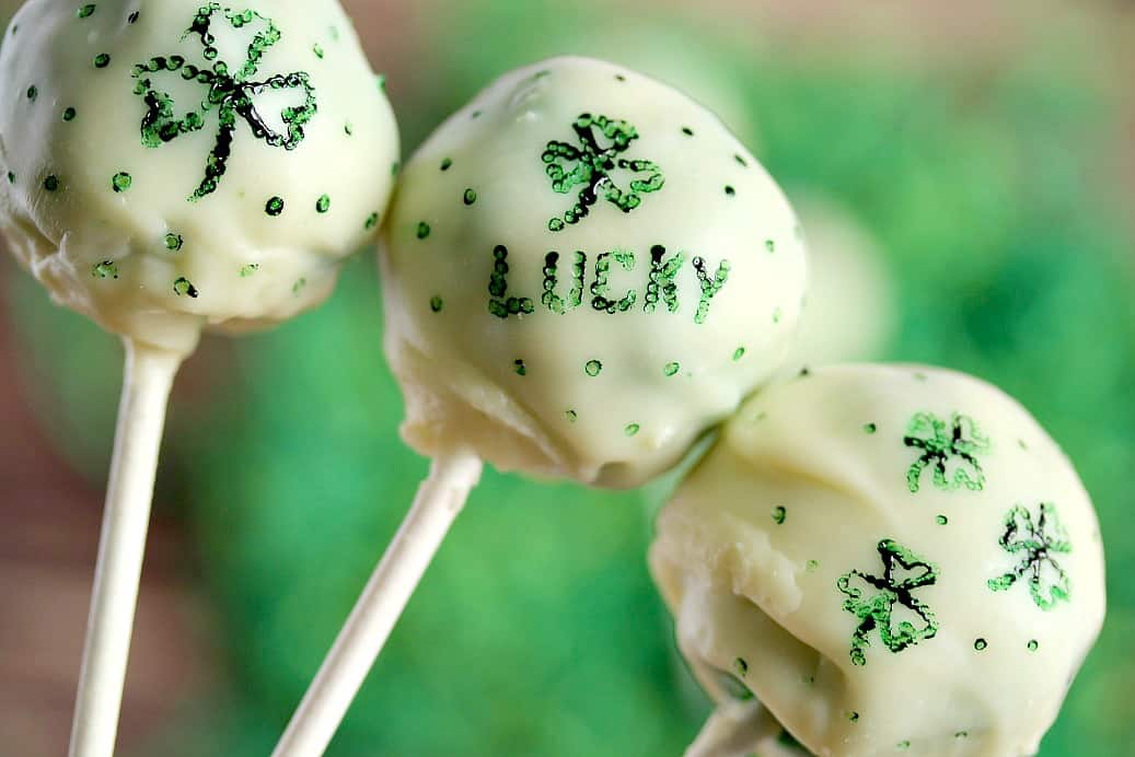Close Up of Decorations on 3 white chocolate covered cake pops