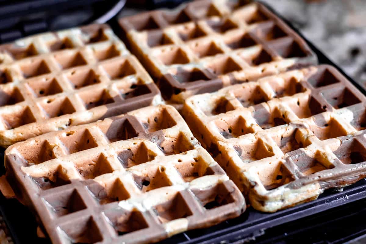 Chocolate peanut butter and chocolate waffles cooked in a waffle maker.