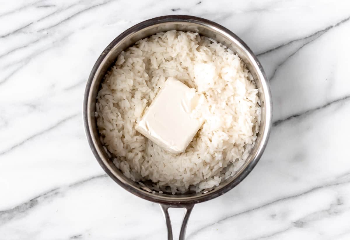 Rice with a block of cream cheese on top.