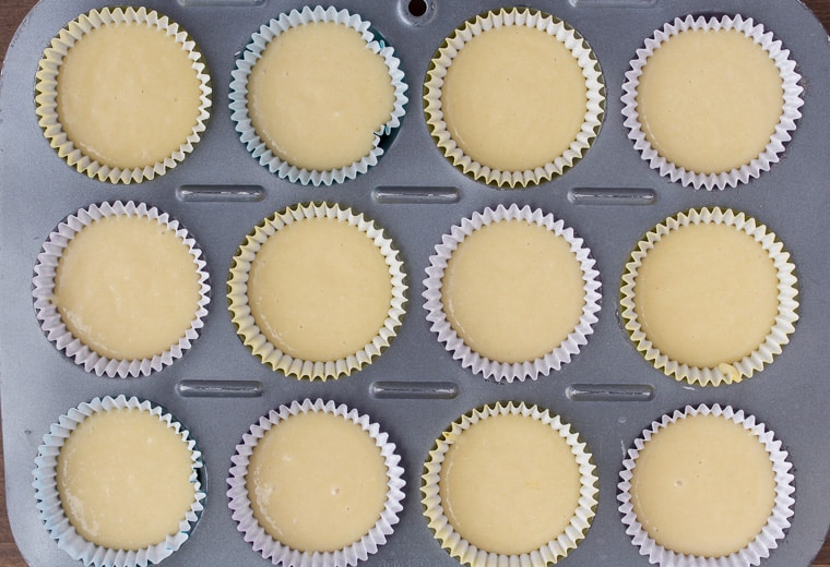 Cupcake pan filled with liners and vanilla cupcake batter