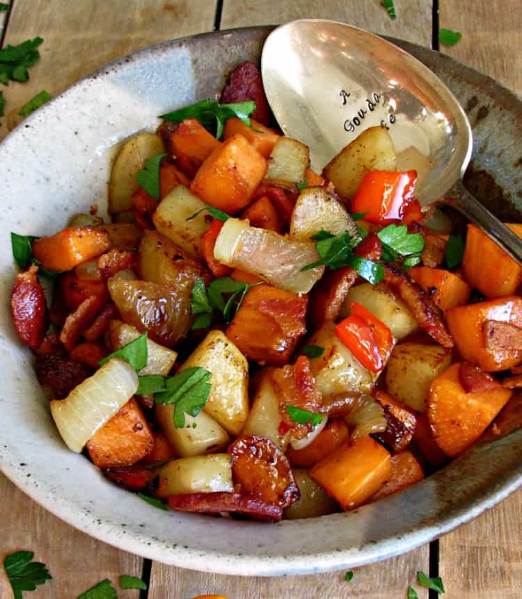 Bacon Sweet Potato Hash in a silver bowl with a spoon on a wood background