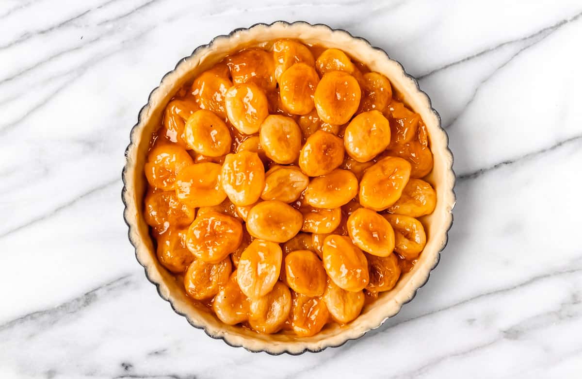 Apricots and apricot jam in the tart pan prior to baking.