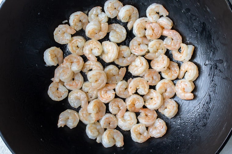 Cooked shrimp in a black skillet