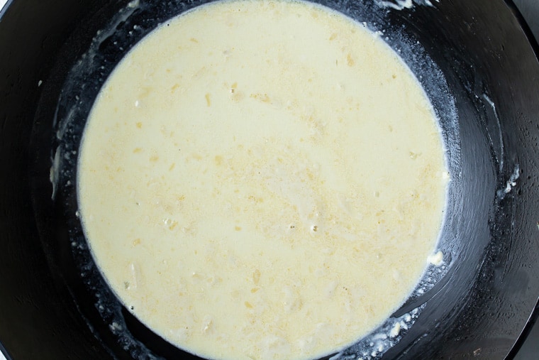 Parmesan sauce in a black skillet