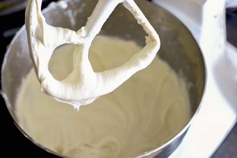No-bake Lemon Cheesecake batter in a mixing bowl with the paddle raised