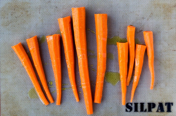 Raw Carrots on a Baking Sheet with Olive OIl