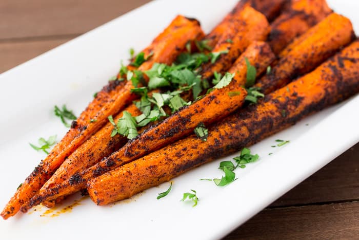 Roasted Chili Spiced Carrots on a White Plate with Cilantro 