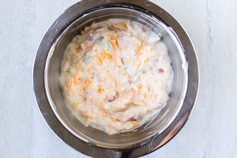 Bacon Ranch Dressing in a silver bowl over a white background