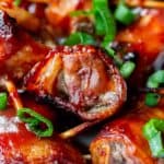 Close up of barbecue bacon wrapped beef bites with green onions
