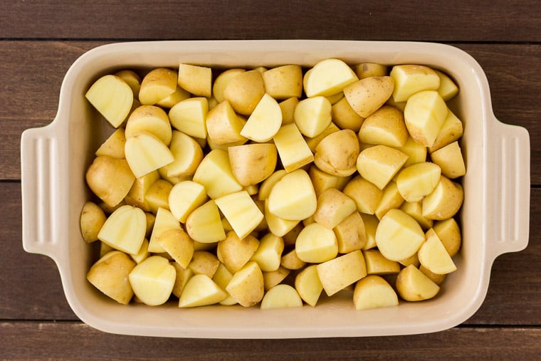 Diced Potatoes in a Baking Dish over a wood background
