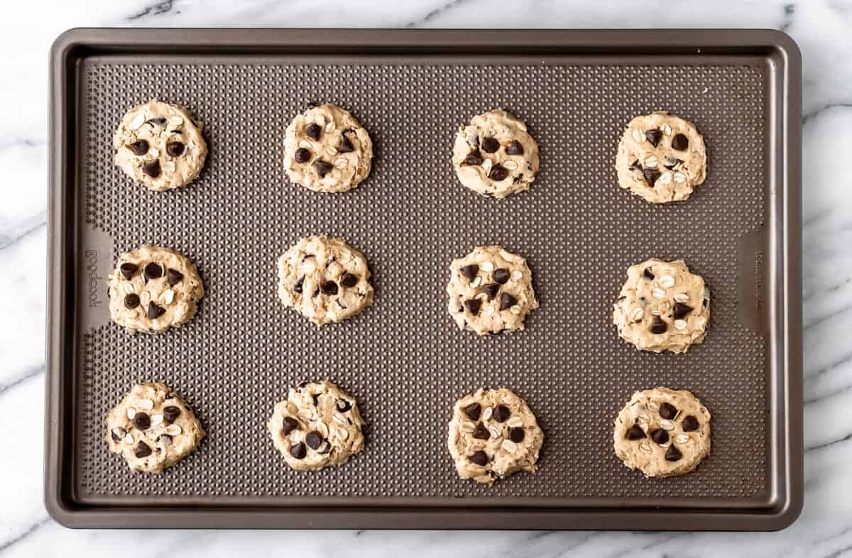 Cookie dough balls on a baking sheet.