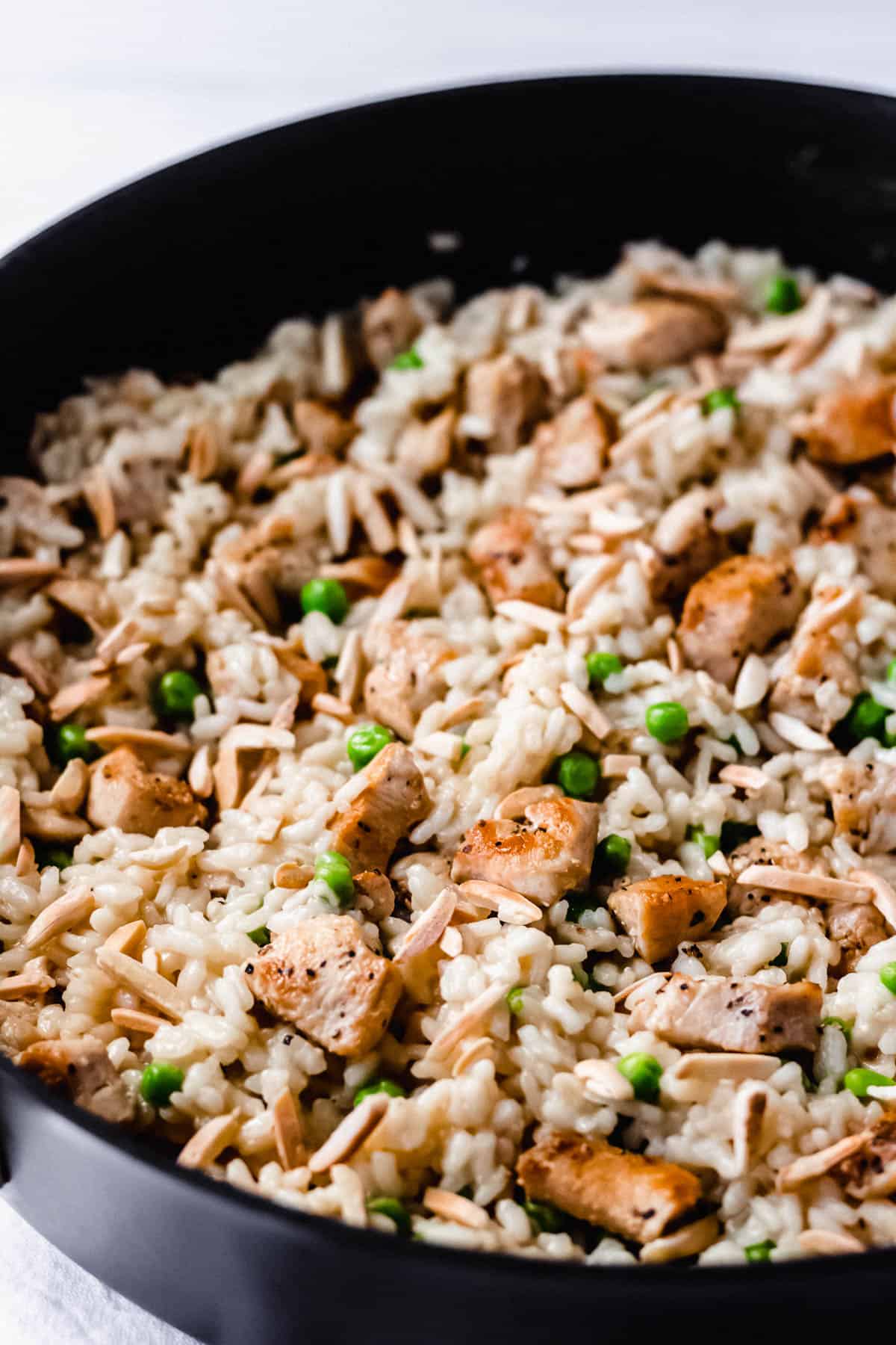 Close up on Chicken Risotto in a deep black skillet