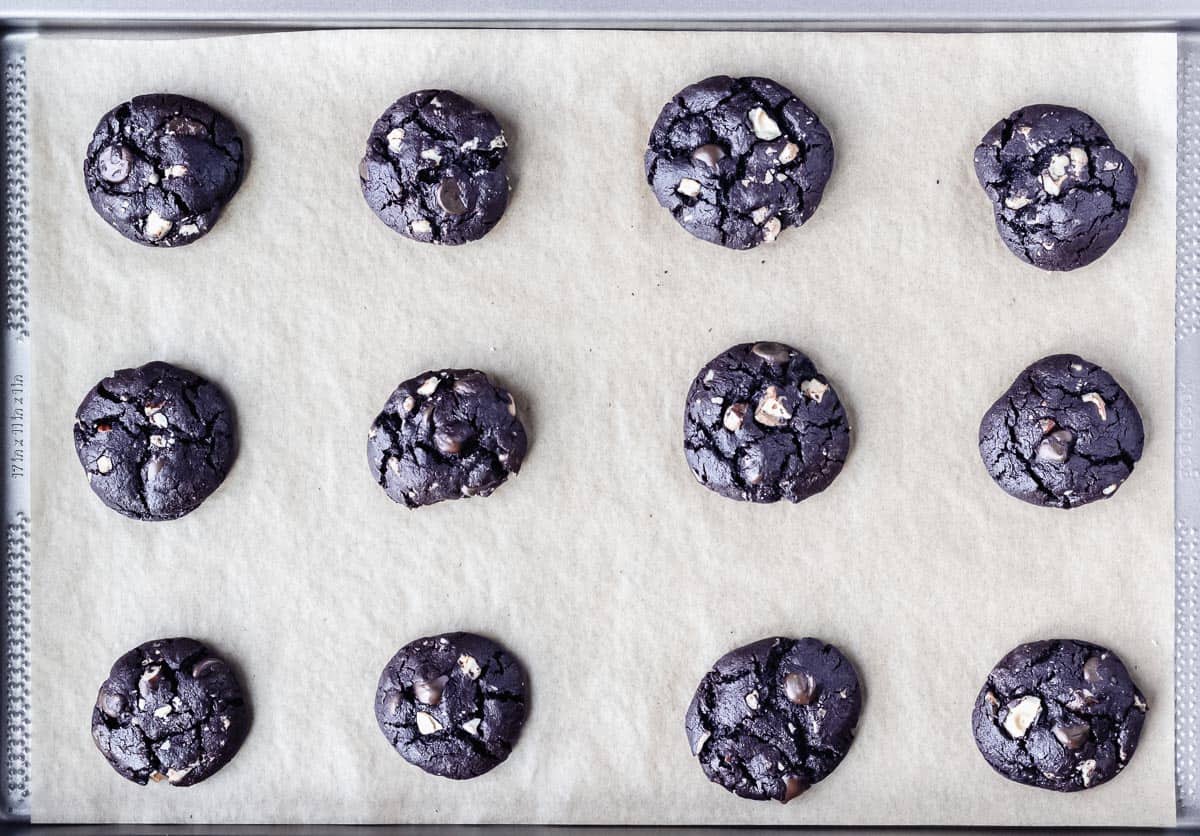 Baked Dark Chocolate Hazelnut Cookies on a parchment paper lined baking sheet
