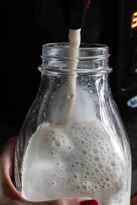 Dispensing Homemade Milk into a Glass Jar