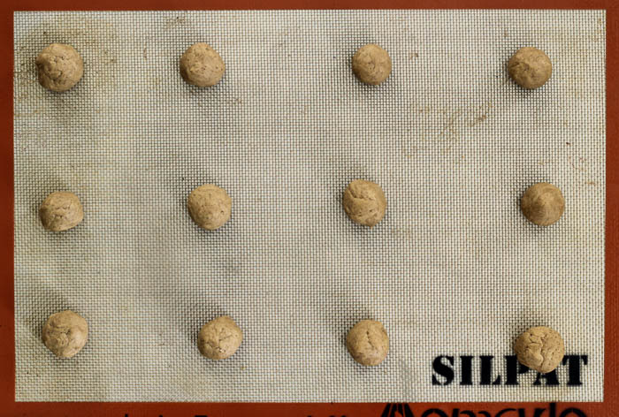 Cookie Dough Balls on Baking Sheet with a silpat mat