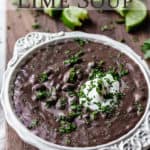 A bowl of black bean and lime soup with text overlay