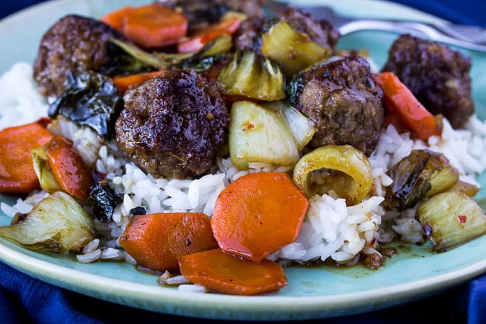 Orange-Glazed Meatballs with Bok Choy and Jasmine Rice on a Green Plate