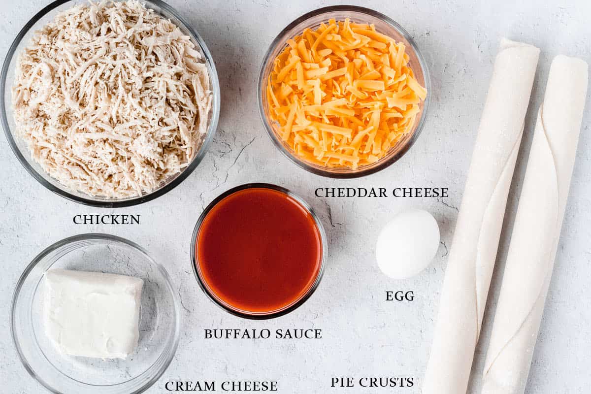 Ingredients for buffalo chicken hand pies on a white background with labels