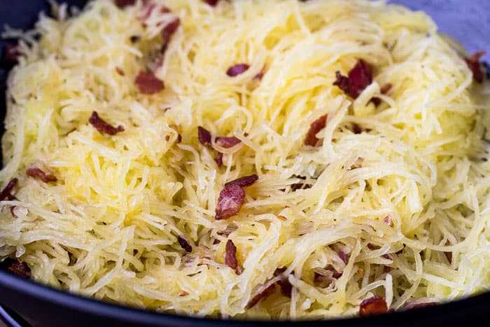 Spaghetti Squash Tossed with Bacon Mixture in a skillet close up