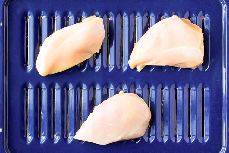 3 Chicken Breasts on a blue broiler pan