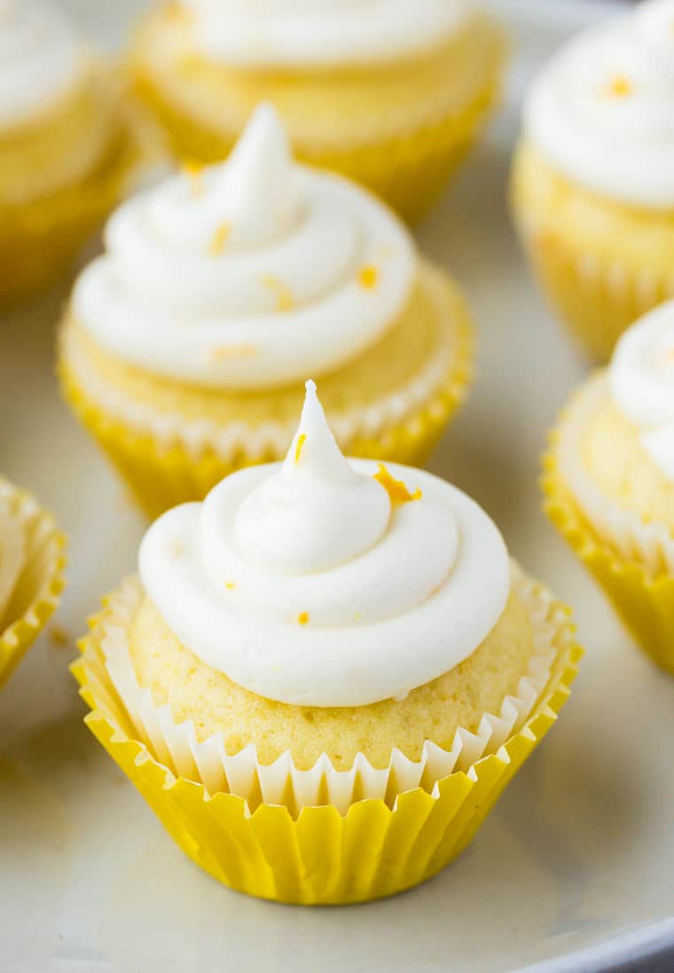 Close up of a mini lemon cupcake with more in the background