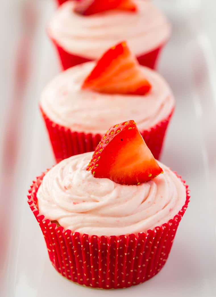 Close up of 3 Strawberry Cupcakes on a white background