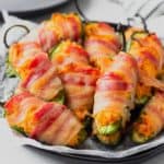 Close up of buffalo chicken jalapeno poppers on a black plate