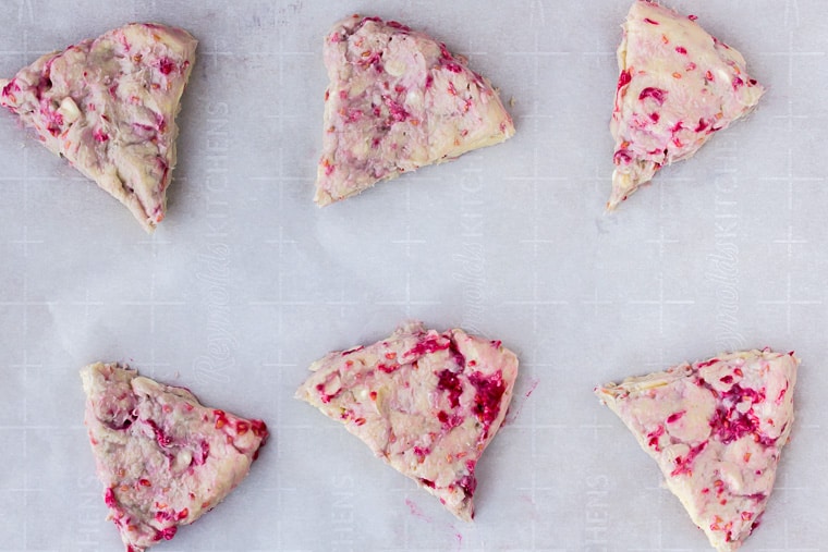 6 White Chocolate Raspberry Scones on parchment paper before baking