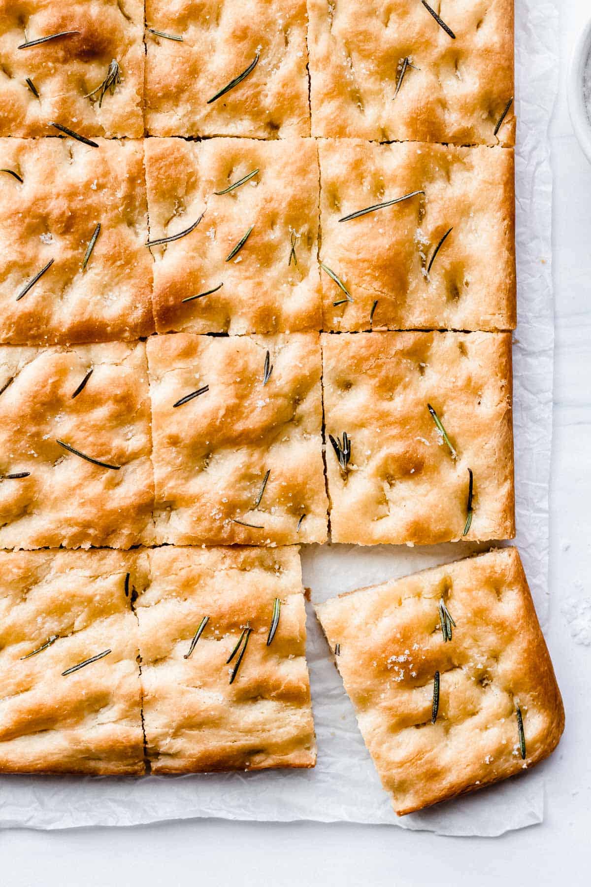 Rosemary Foccacia cut in squares with one square pulled out some