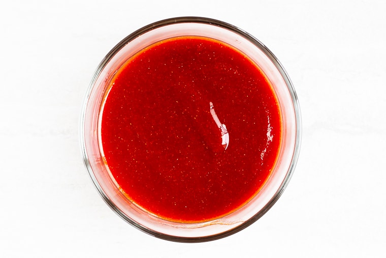 Honey Barbecue Sauce in a glass bowl over a white background