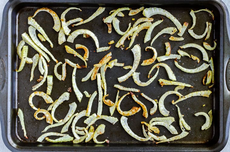 Slices of roasted fennel on a baking sheet