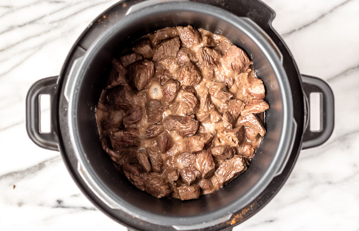 Chunks of beef cooked in an Instant Pot.