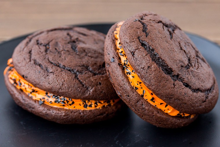 2 Halloween Whoopie Pies close up on a Black Plate