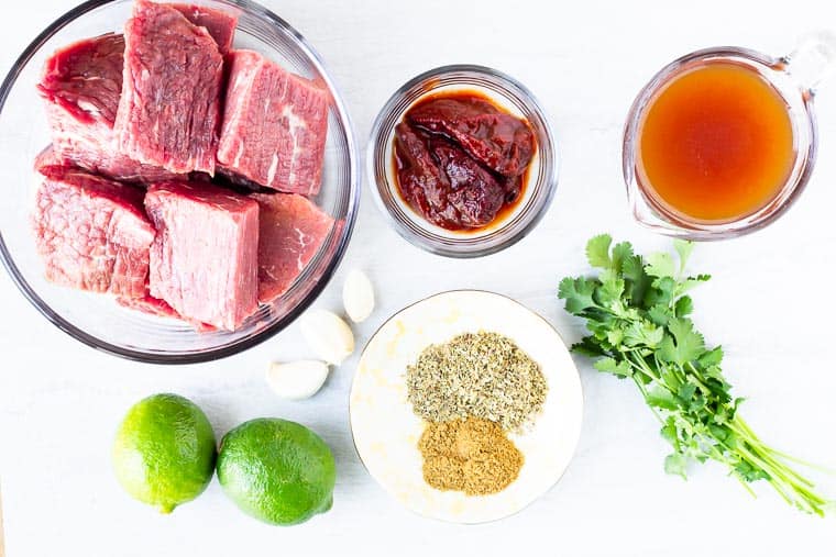 Ingredients for beef barbacoa on a white background