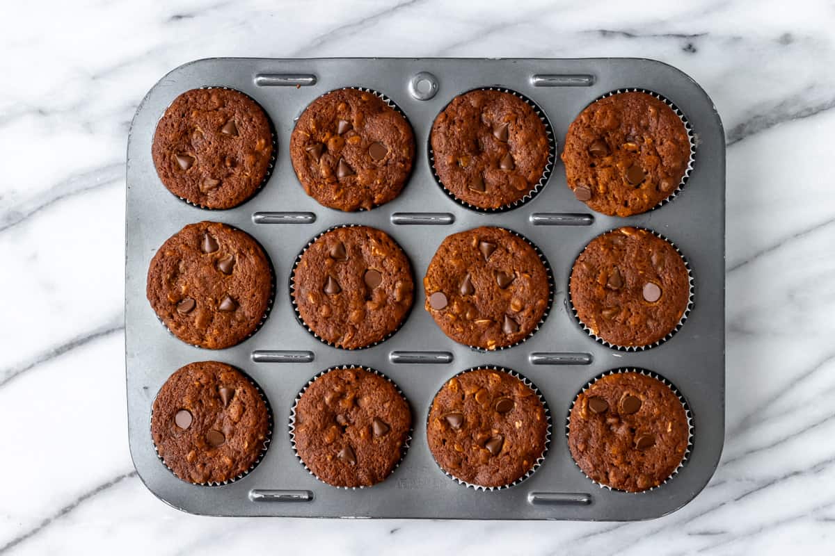 Baked pumpkin chocolate chip muffins in a muffin tin.